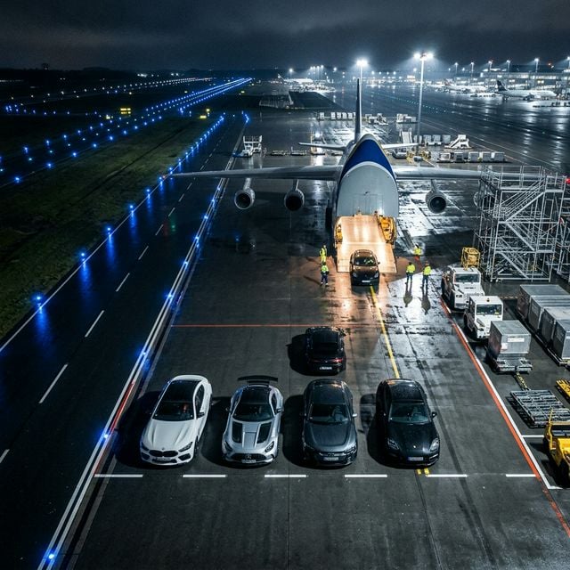Fleet of luxury cars on airport tarmac